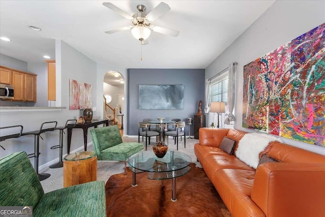 living room with carpet floors and ceiling fan