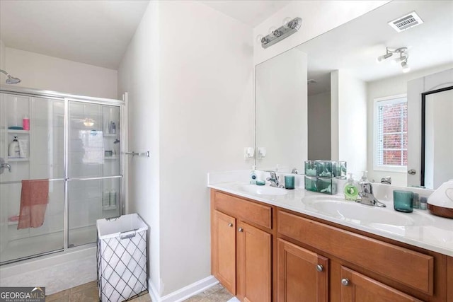 bathroom featuring vanity and a shower with shower door