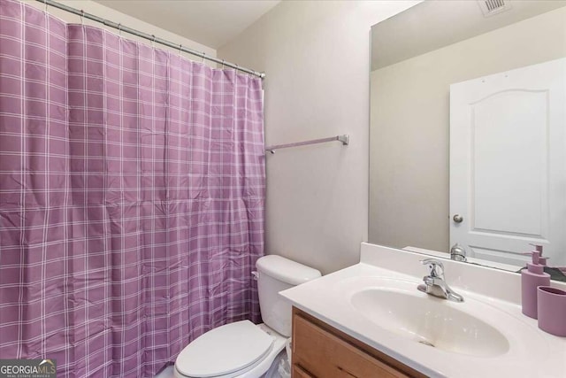 bathroom with vanity and toilet