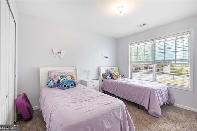 carpeted bedroom featuring a closet