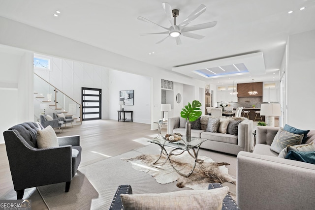 living room with ceiling fan and light hardwood / wood-style flooring