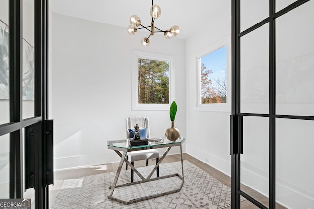 office area featuring hardwood / wood-style floors and a chandelier