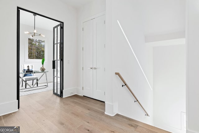 interior space with light hardwood / wood-style floors and a chandelier