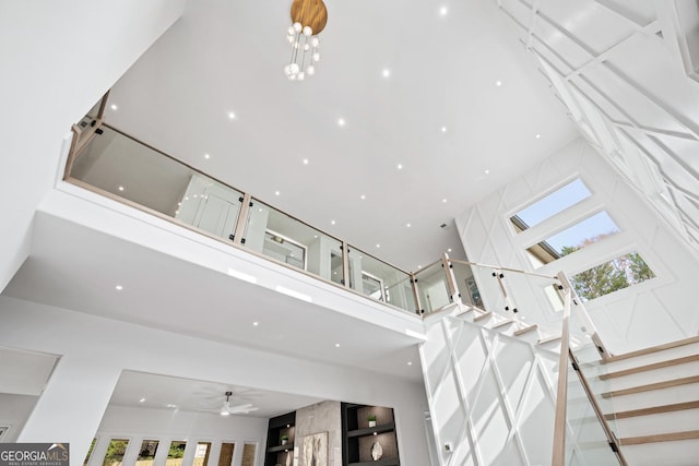 interior details featuring ceiling fan and a premium fireplace