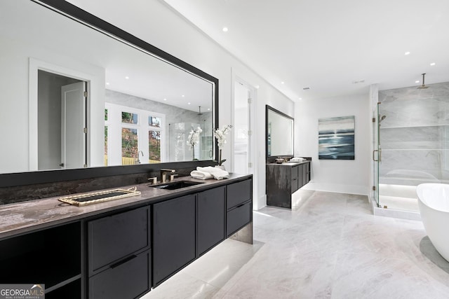 bathroom featuring vanity and independent shower and bath