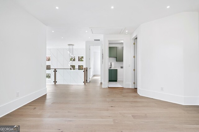 unfurnished living room featuring light hardwood / wood-style flooring and sink