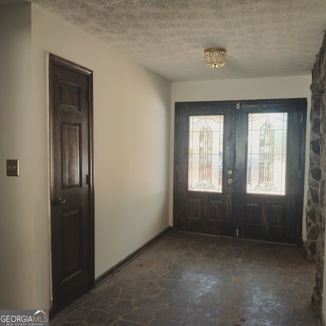 entrance foyer featuring a textured ceiling