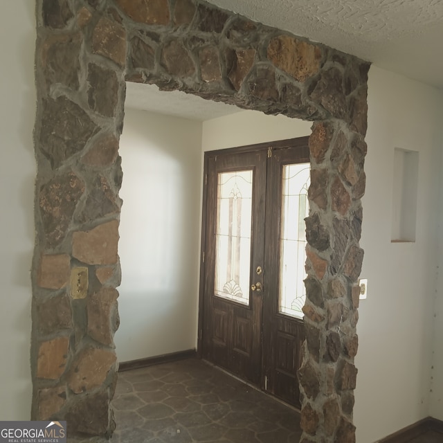 entrance foyer featuring a textured ceiling