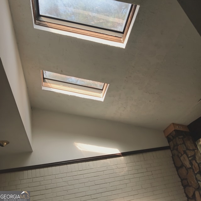 room details with tile patterned flooring and a skylight