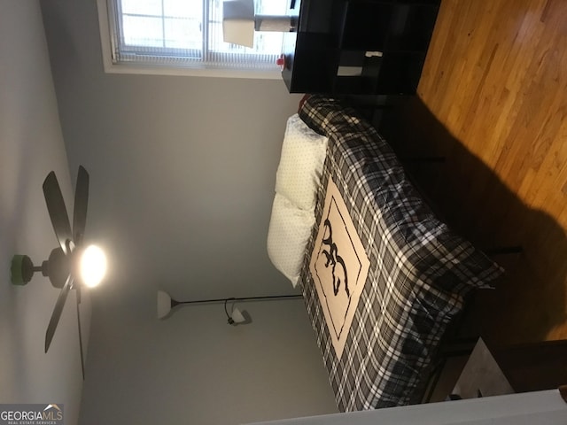 bedroom featuring wooden walls