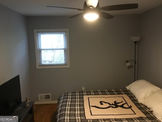 bedroom with hardwood / wood-style floors and ceiling fan