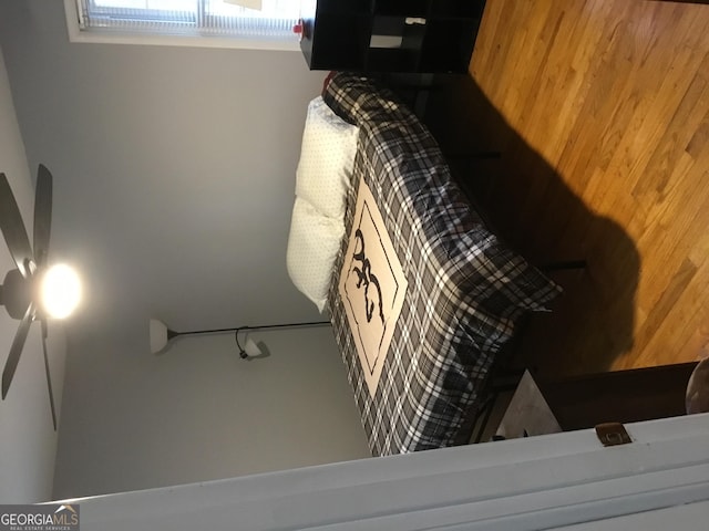 bedroom featuring wood walls