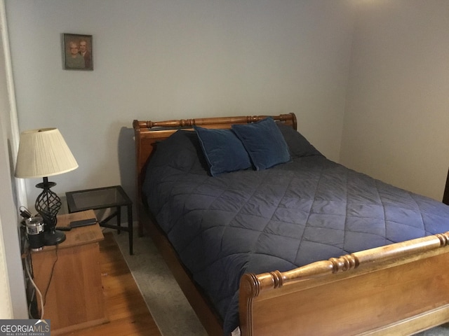 bedroom with wood-type flooring