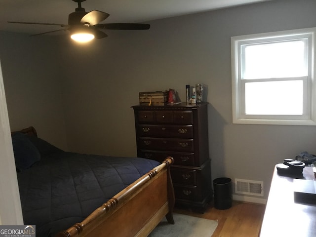 bedroom with ceiling fan and light wood-type flooring