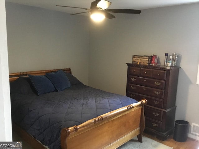 bedroom with ceiling fan and light wood-type flooring