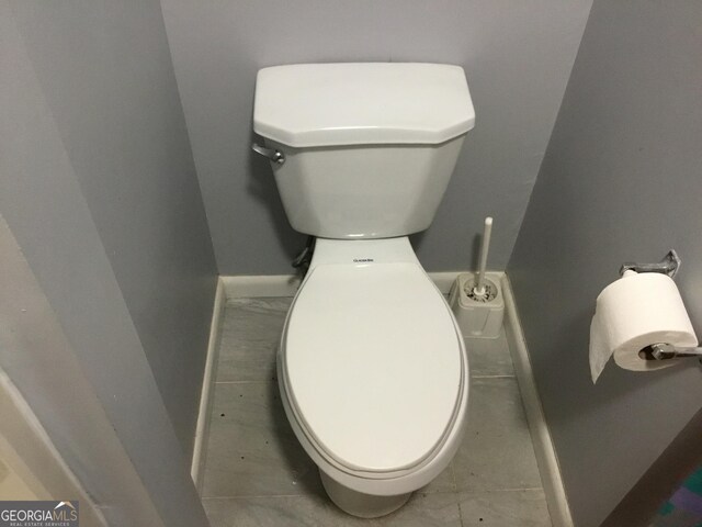 bathroom featuring tile patterned flooring and toilet