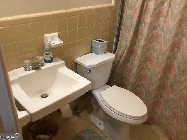 bathroom featuring tile walls, sink, tile patterned floors, and toilet