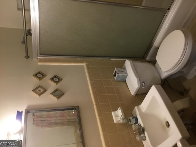 bathroom with an enclosed shower and toilet