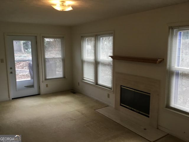 unfurnished living room featuring light carpet