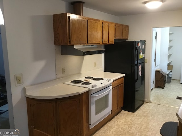 kitchen with black fridge and white range with electric cooktop