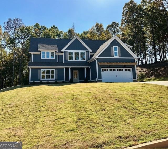 craftsman-style home with a garage and a front lawn