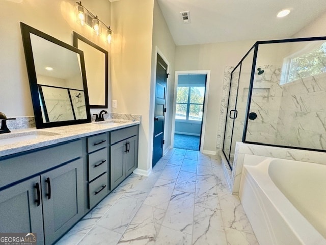 bathroom with vanity and shower with separate bathtub