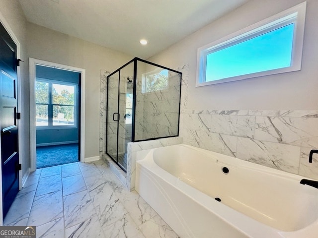 bathroom featuring separate shower and tub