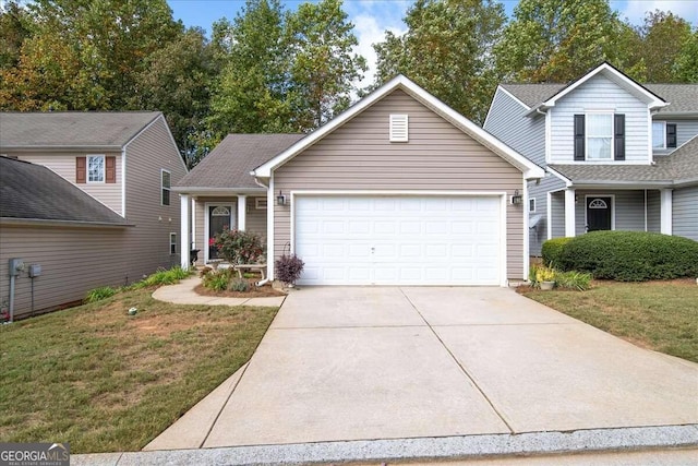 view of front of home with a garage and a front lawn