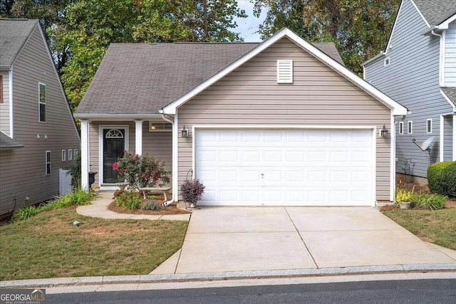 view of front of property featuring a garage and a front lawn