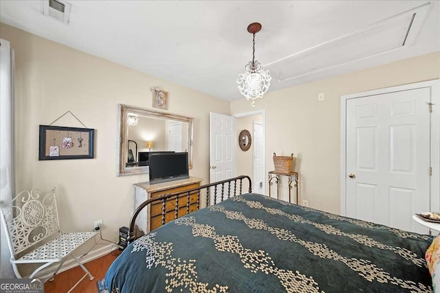 bedroom featuring an inviting chandelier and hardwood / wood-style floors