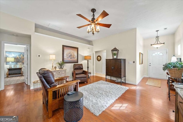 living room with ceiling fan and light wood-type flooring