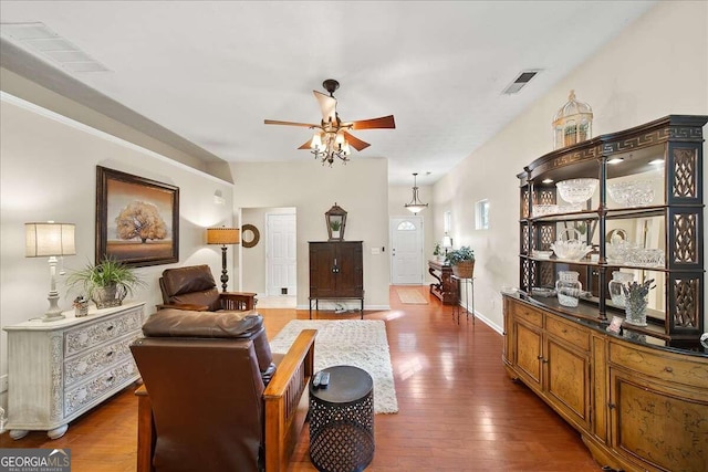 living room featuring dark wood-type flooring and ceiling fan