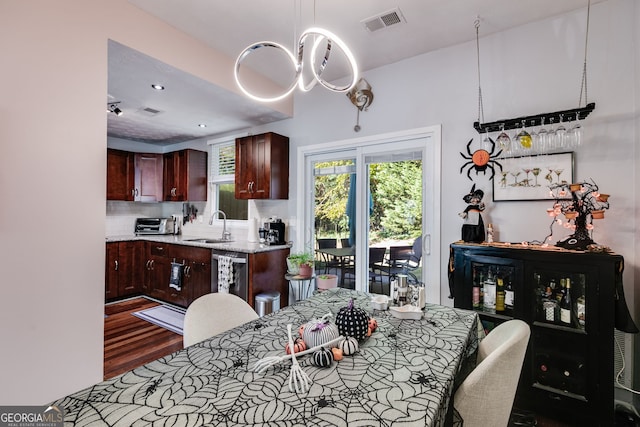 dining room featuring sink and dark hardwood / wood-style flooring