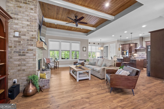 living room featuring light hardwood / wood-style floors, a brick fireplace, ceiling fan, and wooden ceiling