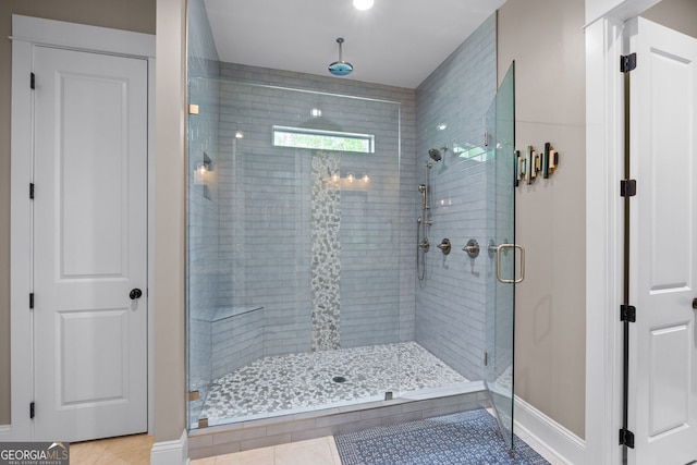 bathroom featuring tile patterned flooring and an enclosed shower