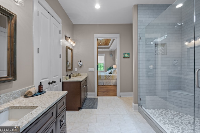 bathroom featuring tile patterned flooring, vanity, and walk in shower