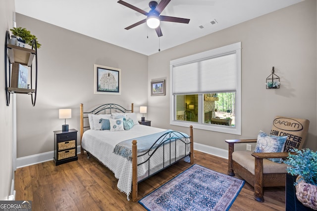 bedroom featuring ceiling fan and dark hardwood / wood-style floors