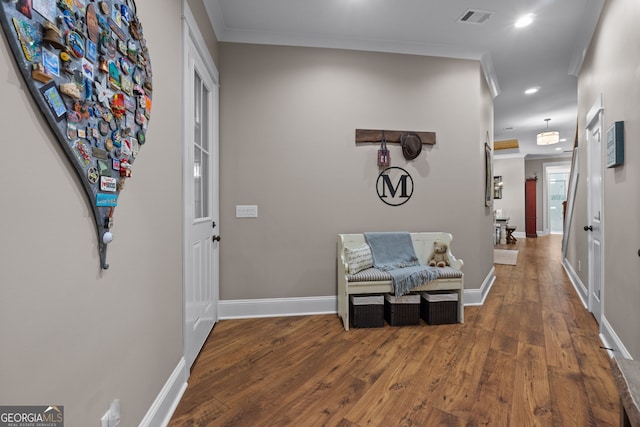 hallway with crown molding and hardwood / wood-style floors