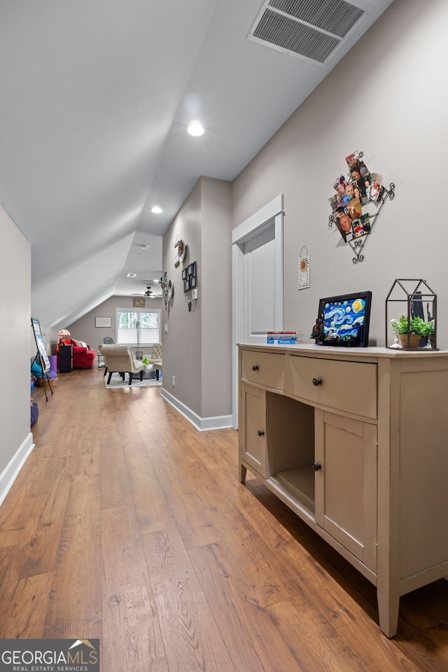 interior space featuring light hardwood / wood-style floors and lofted ceiling