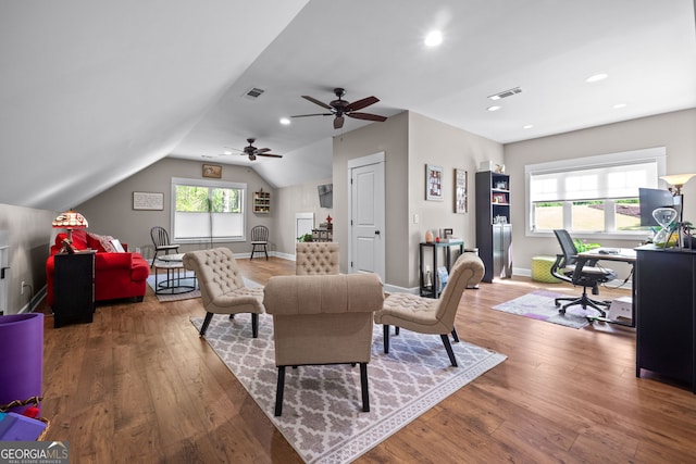 interior space featuring ceiling fan, wood-type flooring, and vaulted ceiling