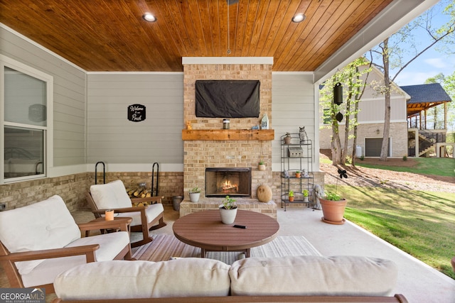 view of patio with an outdoor brick fireplace