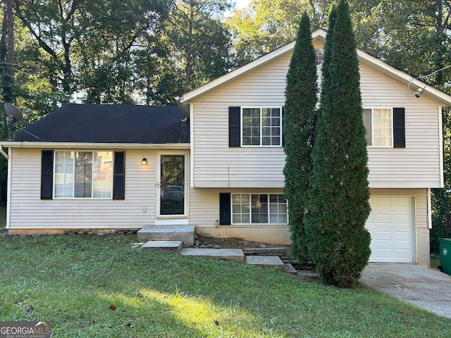 tri-level home featuring a front yard and a garage