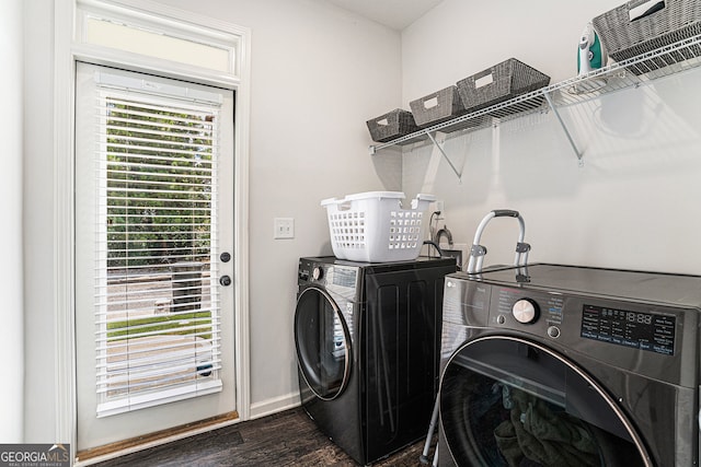 washroom featuring dark hardwood / wood-style flooring and washing machine and clothes dryer