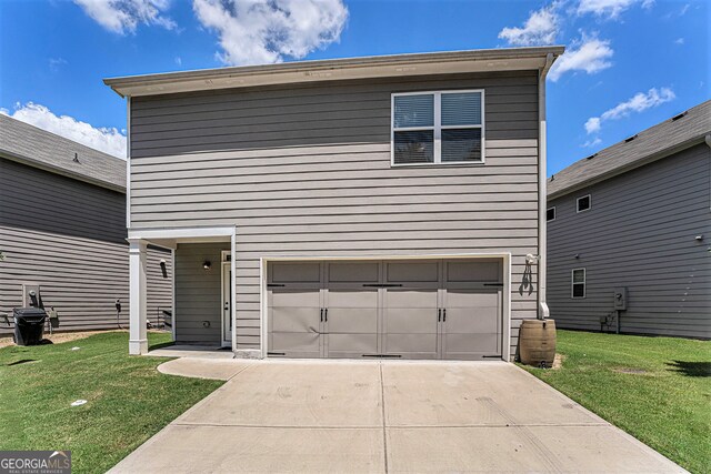 view of front facade with a garage and a front lawn