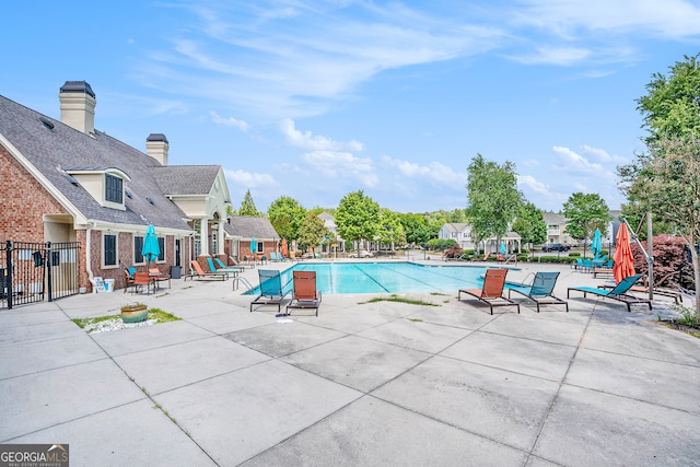 view of swimming pool with a patio