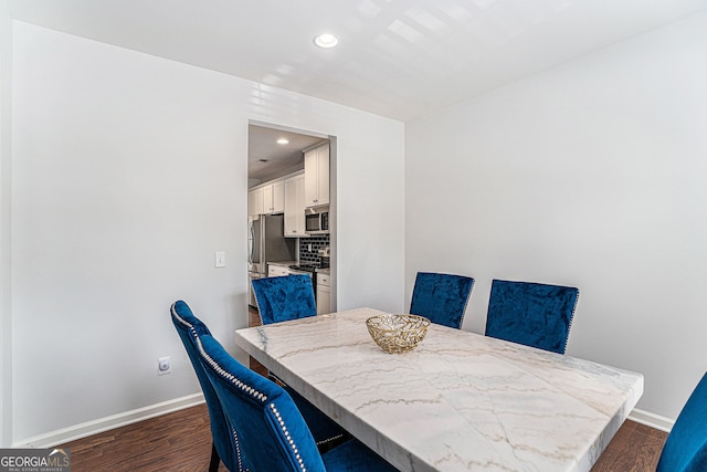 dining space with dark wood-type flooring