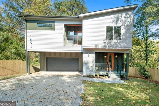 modern home with a front lawn and a garage