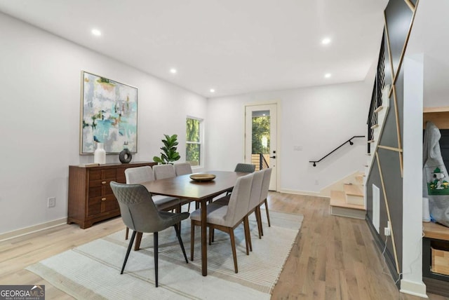 dining space with light hardwood / wood-style flooring