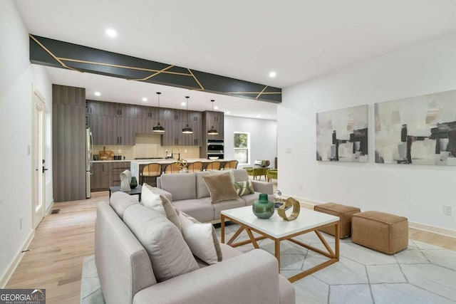 living room featuring light hardwood / wood-style floors and sink