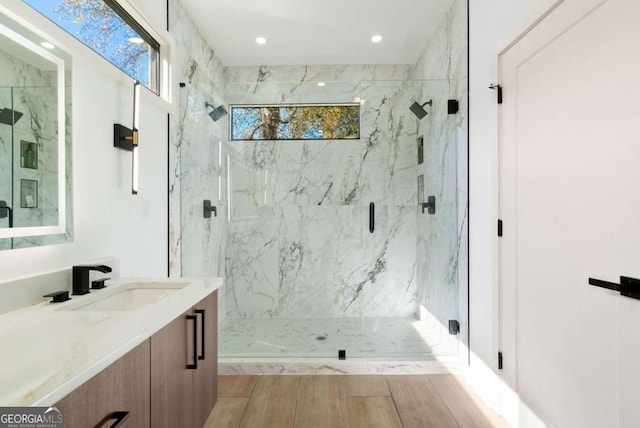 bathroom with vanity and a shower with shower door